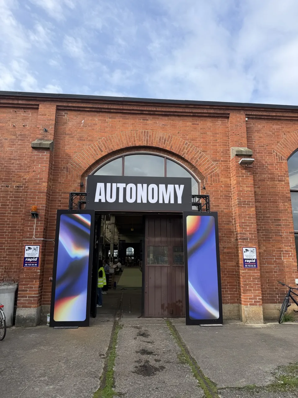 The brick entrance to Lokstallarna under the Autonomy sign